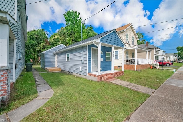 bungalow-style home with a front lawn and covered porch