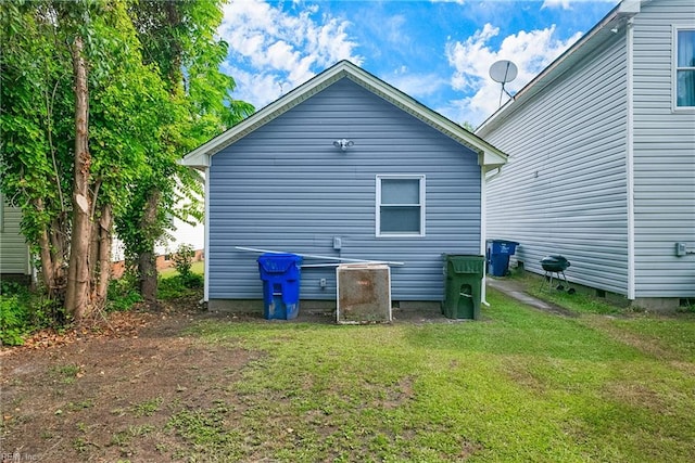 rear view of property with a yard