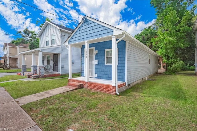 bungalow-style home with covered porch and a front yard