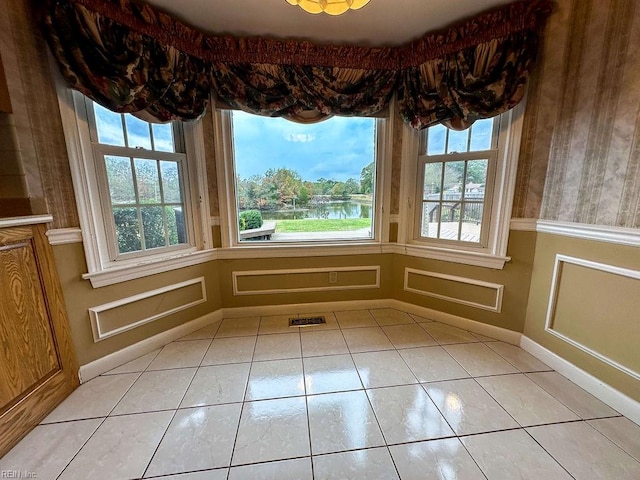 unfurnished dining area with light tile patterned floors and a wealth of natural light