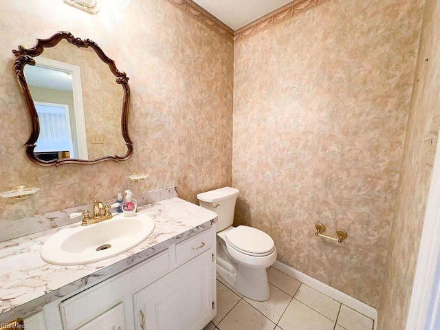 bathroom with tile patterned flooring, vanity, and toilet