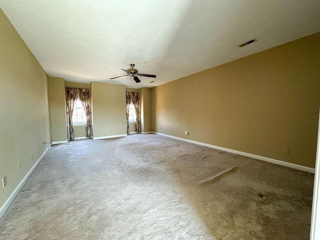 carpeted spare room with ceiling fan