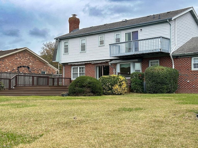 back of house with a lawn and a deck