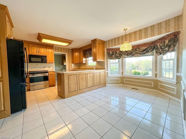 kitchen with black appliances, decorative backsplash, light tile patterned floors, and sink