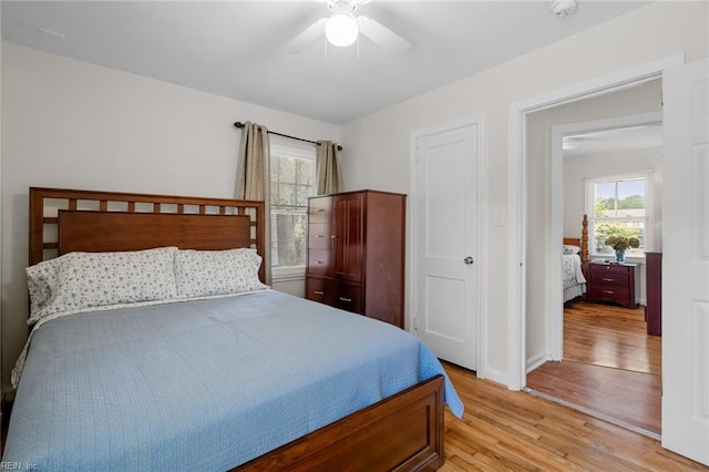 bedroom with ceiling fan and light hardwood / wood-style flooring