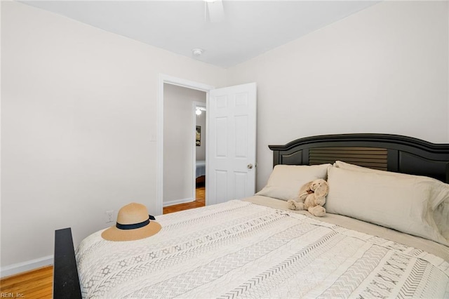 bedroom with hardwood / wood-style flooring and ceiling fan