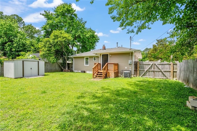 back of house featuring a shed, a yard, and central air condition unit