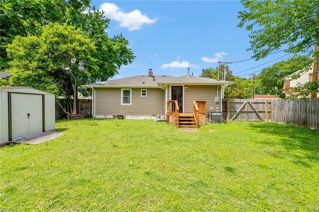 rear view of house with a yard and a shed