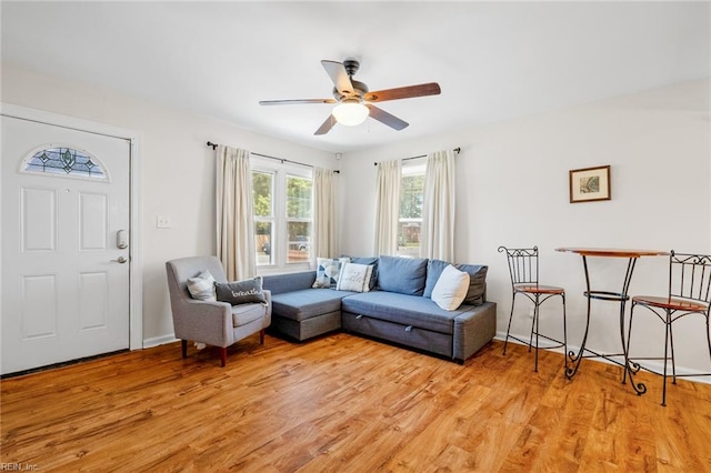 living room featuring ceiling fan and light hardwood / wood-style flooring