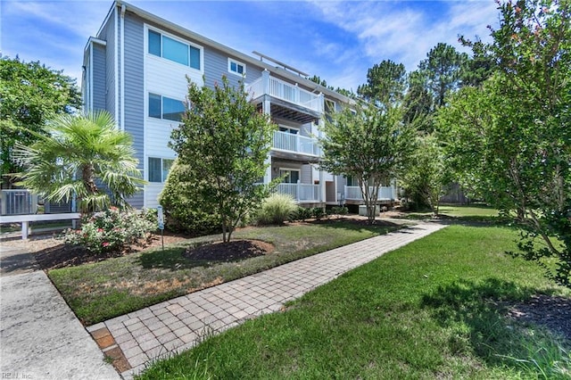 view of property's community with a lawn