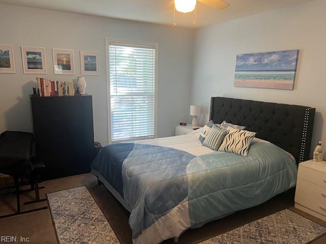 bedroom with ceiling fan and dark hardwood / wood-style floors