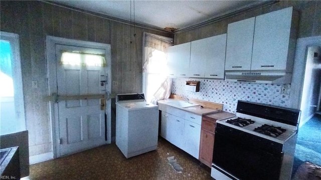 kitchen featuring white cabinetry, white range with gas cooktop, washer / clothes dryer, and sink