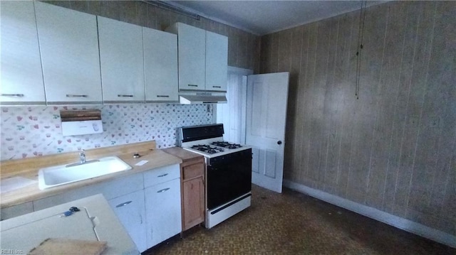 kitchen featuring white cabinets, white range oven, and sink