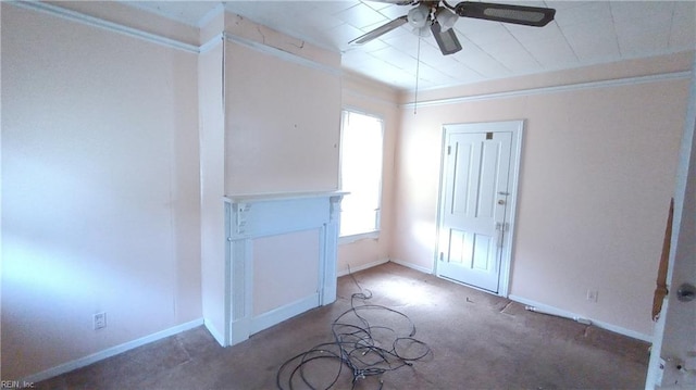 carpeted empty room with ceiling fan and crown molding