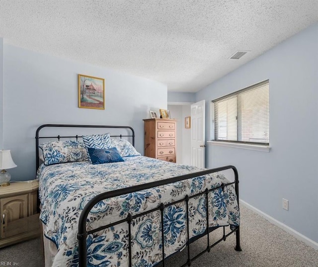 carpeted bedroom featuring a textured ceiling