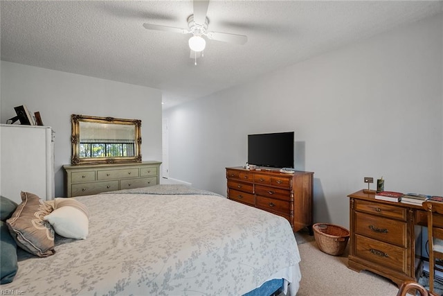 carpeted bedroom with ceiling fan and a textured ceiling