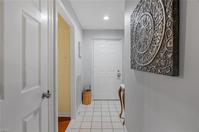 doorway to outside featuring light tile patterned flooring