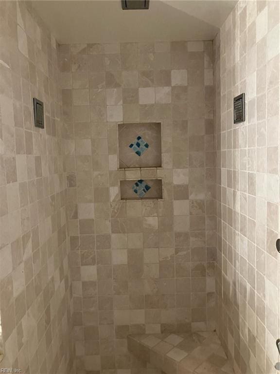 bathroom with tiled shower