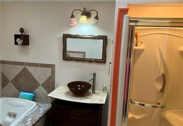 bathroom with vanity and a bath