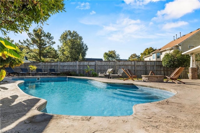 view of swimming pool featuring a patio area and an outdoor fire pit