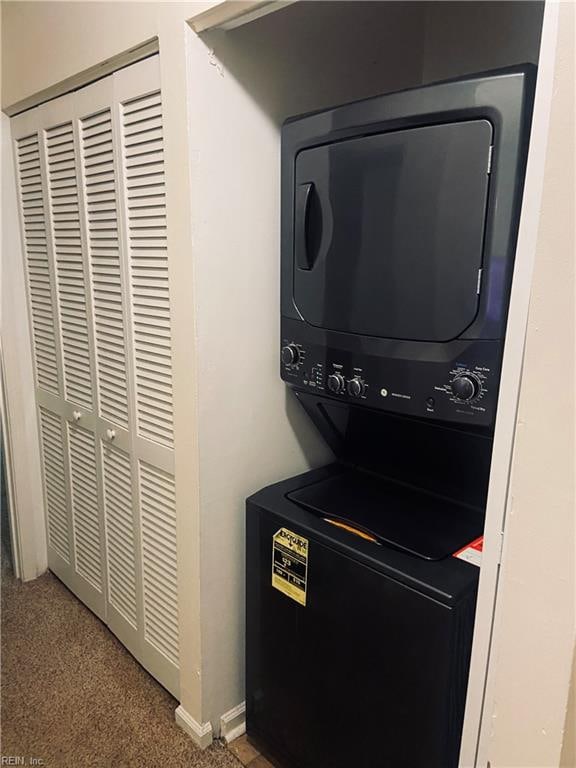 laundry area featuring stacked washer and clothes dryer