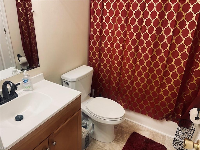 bathroom featuring curtained shower, vanity, and toilet