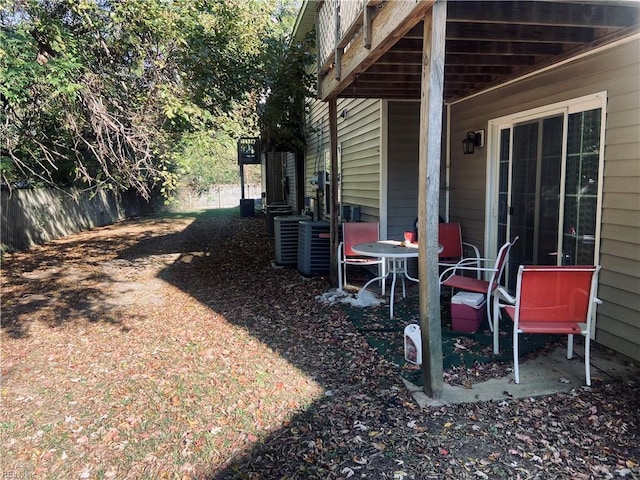 view of yard featuring central AC and a deck