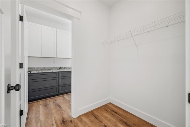 walk in closet featuring light hardwood / wood-style flooring