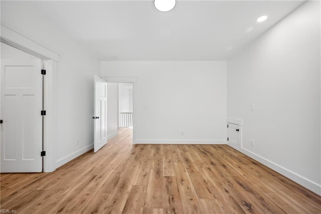 unfurnished room with light wood-type flooring