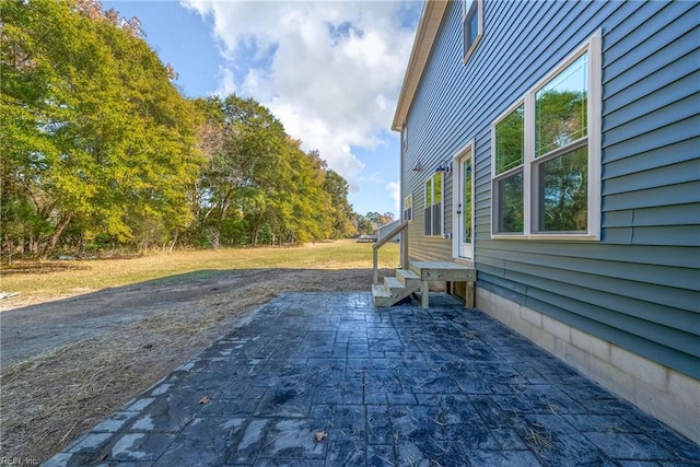 view of side of property with a patio area