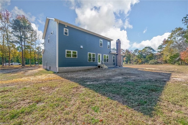 rear view of property with a lawn