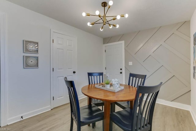 dining area with a notable chandelier and light hardwood / wood-style floors