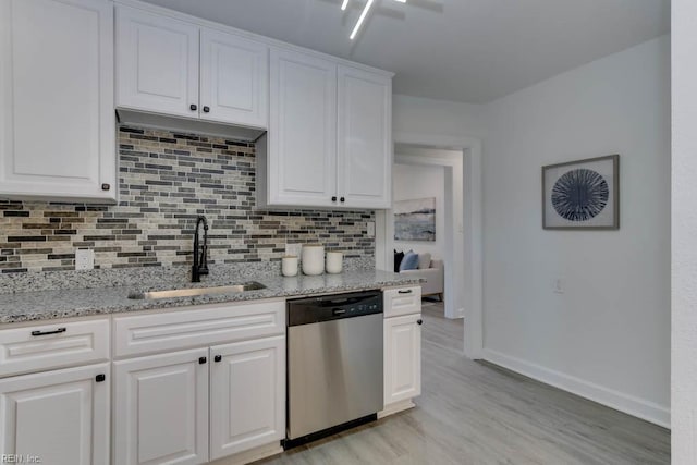 kitchen featuring light stone countertops, dishwasher, sink, white cabinets, and light wood-type flooring