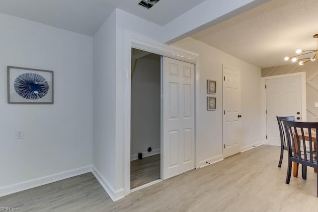 dining room featuring hardwood / wood-style flooring and an inviting chandelier