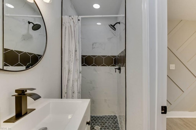 bathroom featuring hardwood / wood-style floors, vanity, and walk in shower