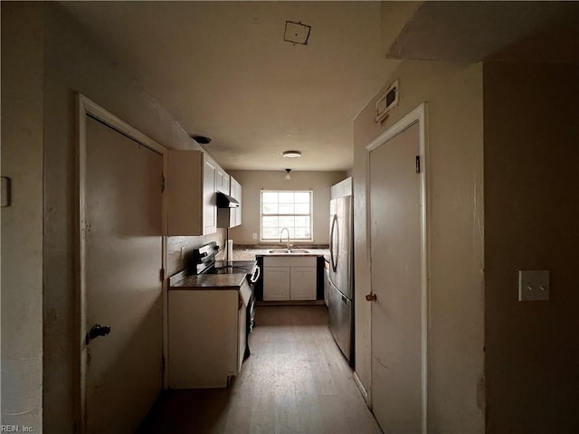 kitchen with light hardwood / wood-style flooring, white cabinets, stainless steel appliances, and sink