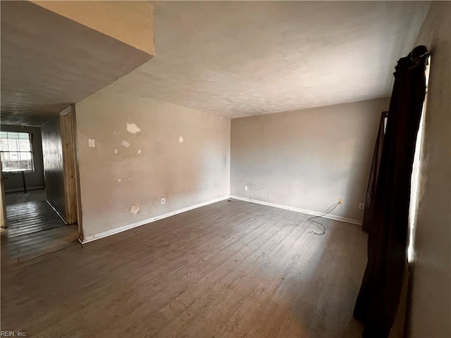 empty room with dark hardwood / wood-style floors