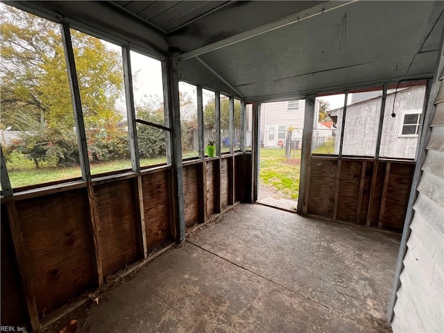 unfurnished sunroom with lofted ceiling