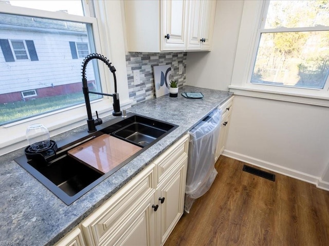 kitchen with dishwasher, tasteful backsplash, plenty of natural light, and sink