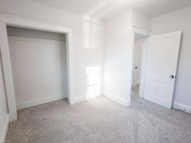 unfurnished bedroom with a closet and carpet floors