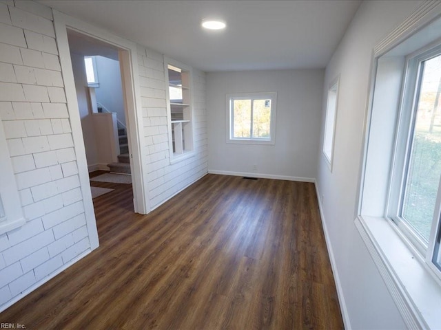 unfurnished room with dark hardwood / wood-style flooring