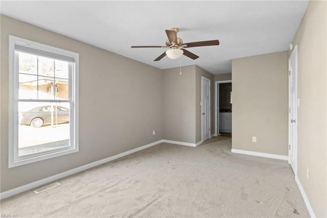 unfurnished bedroom with light colored carpet and ceiling fan