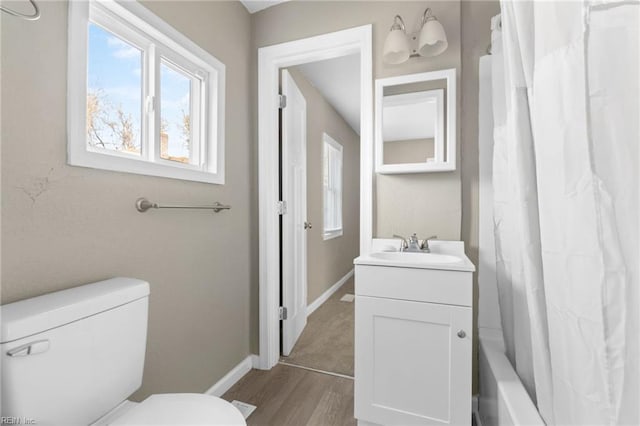 full bathroom with vanity, toilet, wood-type flooring, and shower / bath combo