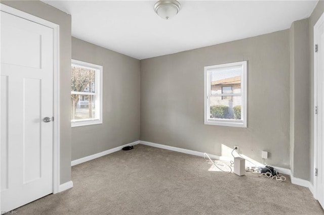 carpeted empty room with plenty of natural light