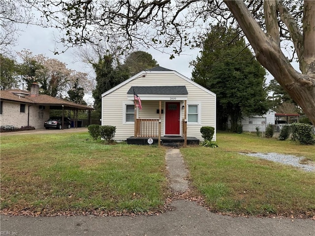 bungalow featuring a front lawn and a carport