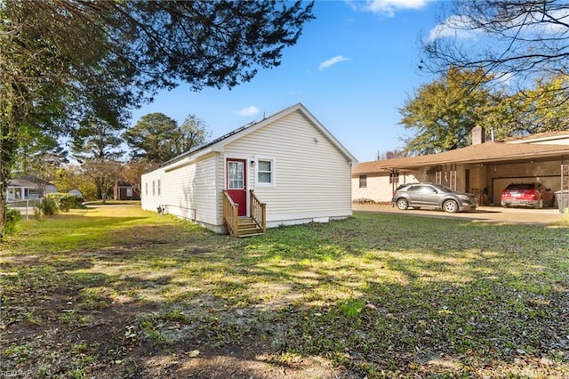 view of home's exterior with a yard and a carport