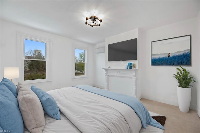 bedroom with light colored carpet and a wall mounted AC