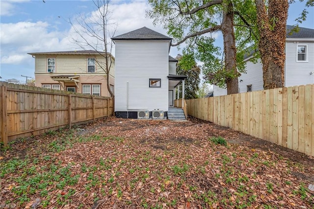 back of house with ac unit