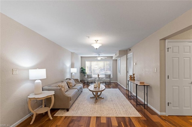 living room with ceiling fan and hardwood / wood-style flooring