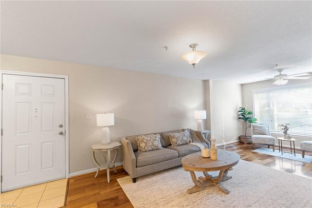 living room featuring ceiling fan and wood-type flooring